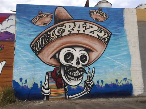 a mural painted on the side of a building with a skeleton wearing a ...