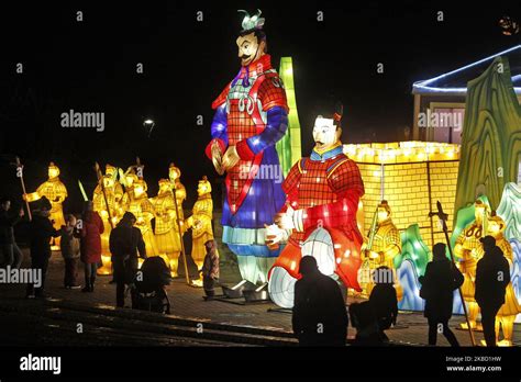 Visitors look on giant installations from lanterns, during the ...