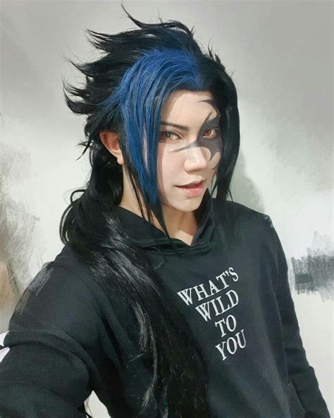 a person with blue hair and black hoodie