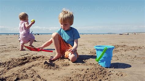 "Children Playing On The Beach" by Stocksy Contributor "Sally Anscombe ...