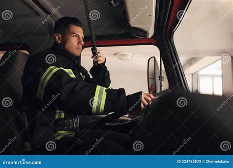 Firefighter Using Radio while Driving Fire Truck Stock Image - Image of ...