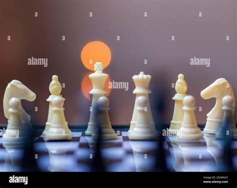 Plastic chess pieces in the foreground Stock Photo - Alamy