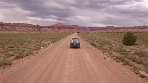 An Aerial Shot Car Drives Through Desert On Stock Footage SBV-307216425 ...