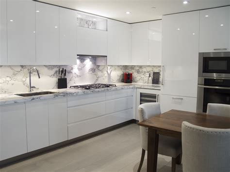 Custom Kitchen Design - White high-gloss handle-less cabinetry with ...