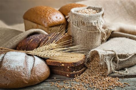 Premium Photo | Bread and wheat on a wooden background