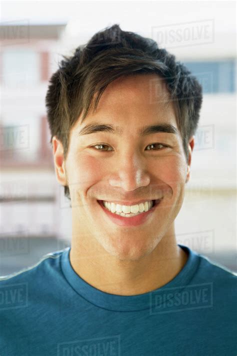 Close up of Asian man smiling - Stock Photo - Dissolve