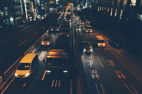 drone view of busy highway interchange surrounded by buildings and ...