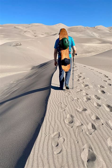 Sandboarding in Colorado (Great Sand Dunes) - Champagne Tastes®