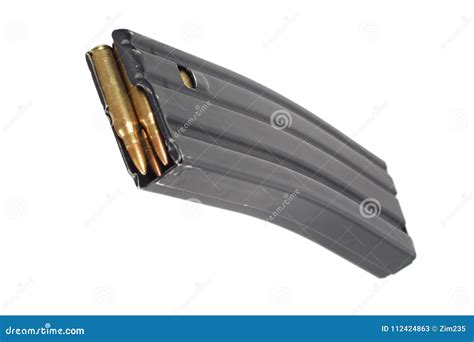 A AR-15 Rifle Magazine Loaded With .223 Caliber Rifle Bullets On A Gray ...