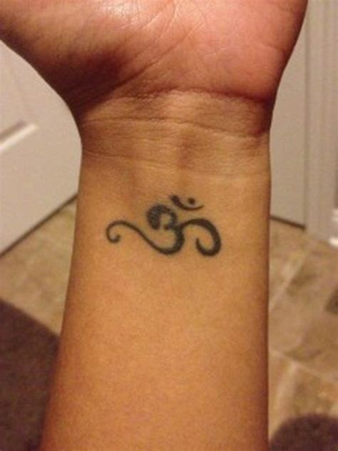 Black Jain Om Tattoo On Wrist | Om tattoo, Om tattoo design, Om wrist ...