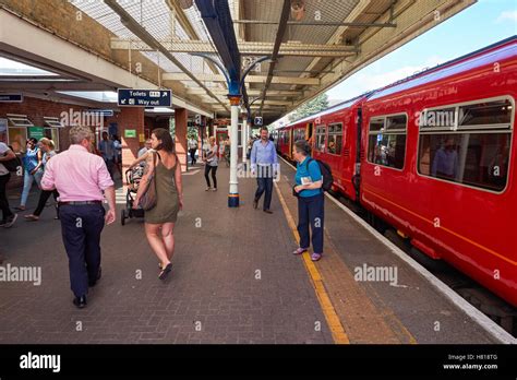 Passengers at Kingston railway station in Kingston upon Thames, England ...