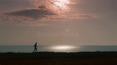 Silhouette Jogger Man on the Beach. Athletic Young Person Running ...