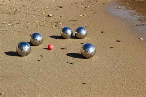 Petanque balls on the sandy beach — Stock Photo © olamiabo #98335816