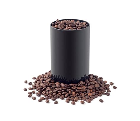 Premium Photo | Electric coffee mill in coffee beans heap