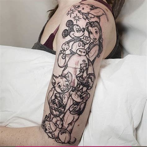 a woman laying in bed with a tattoo on her arm that has an image of ...