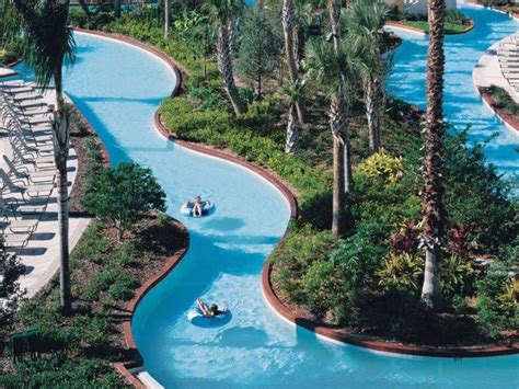 an aerial view of a water park with people in boats and palm trees ...