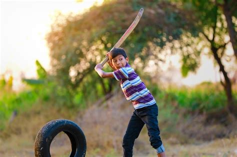 Premium Photo | Rural Indian Child Playing Cricket