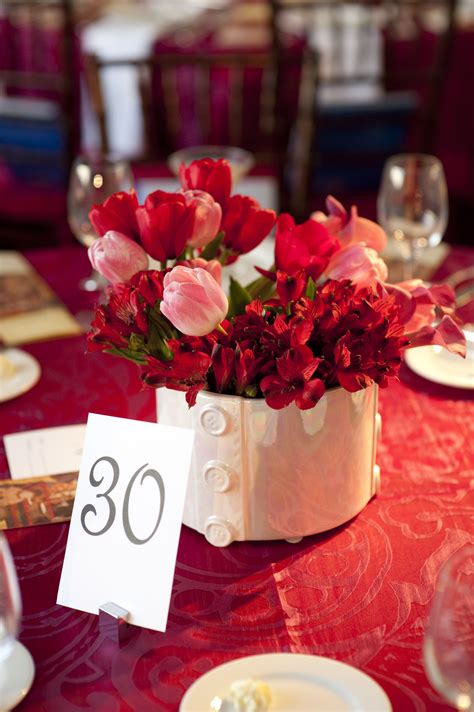 Stunning red floral centerpiece in white vase | Floral centerpieces ...