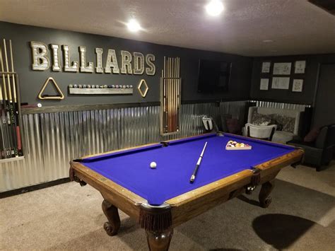 Basement billiards room with lounge areas and a wet bar. Pool table has ...