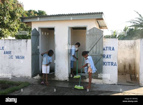 Children clean the latrines at school as part of water and sanitation ...