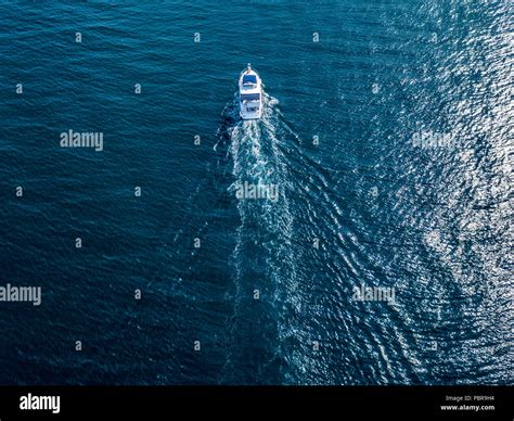 aerial top view of isolated fast speed white motor boat ship on a sea ...