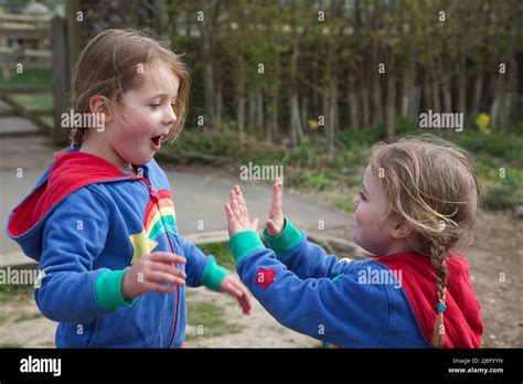 Kids playing Pat a Cake game, UK Stock Photo - Alamy