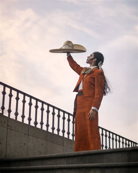 Catrina in Traditional Clothing Holding Sombrero in Raised Arm · Free ...