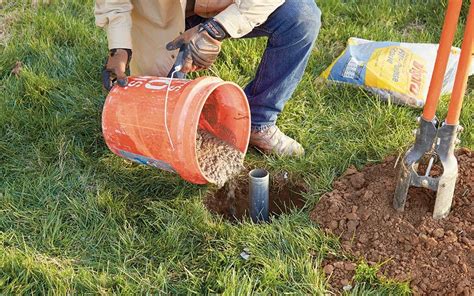 a person setting the ground sleeve of a flag pole with concrete | Flag ...