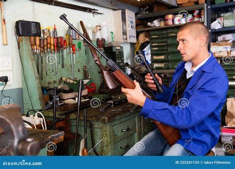 Gunsmith Attaches a Telescopic Sight To Rifle in Weapons Workshop Stock ...