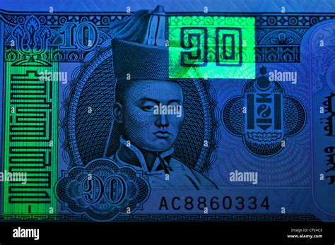 Banknote under ultraviolet light showing security features invisible in ...