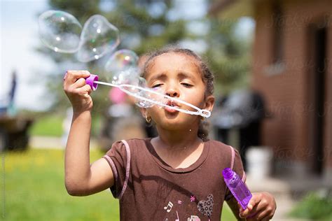 "A Cute Young Child Blowing Bubbles" by Stocksy Contributor "Anya ...