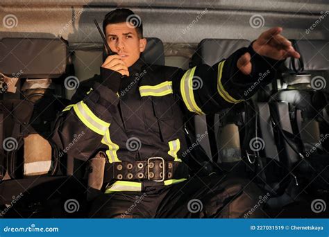 Firefighter Using Portable Radio Set in Fire Truck Stock Image - Image ...