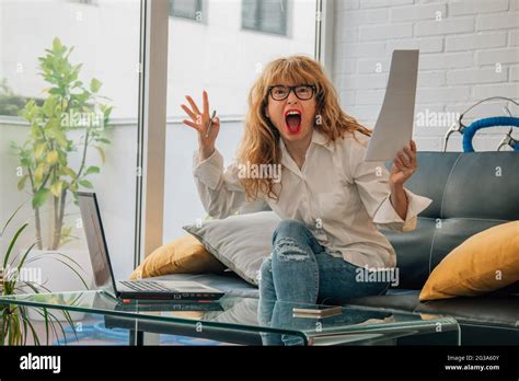 angry woman at home with computer Stock Photo - Alamy