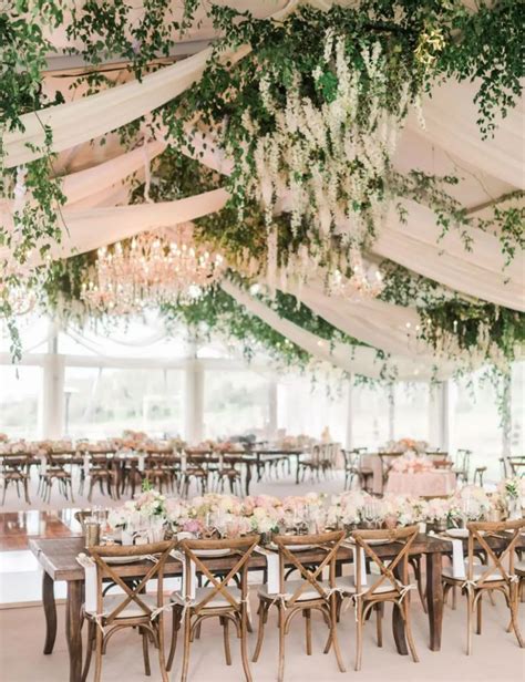 an elegant tented wedding reception with white and pink flowers ...