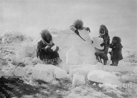 Eskimo Women Building A Snow Igloo by Bettmann