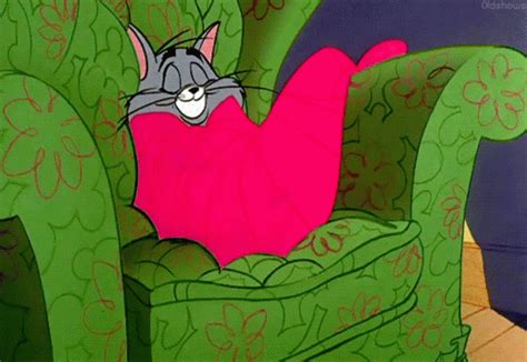 a cartoon cat laying on top of a green chair