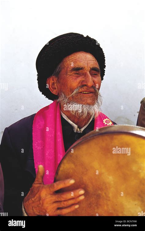 Elderly Tajik musician playing hand drum in a band, Taxkorgan Tajik ...