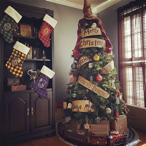 a christmas tree decorated with harry potter stockings