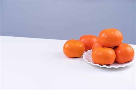 Fresh beautiful sliced sweet persimmon kaki isolated on white kitchen ...