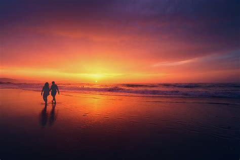 Couple Walking On Beach At Sunset Photograph by Mikel Martinez de Osaba ...