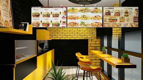 the interior of a fast food restaurant with yellow tables and chairs in ...