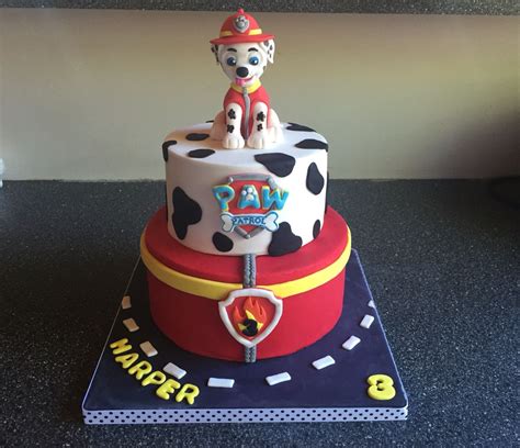 a birthday cake made to look like a fireman on top of a cowgirl