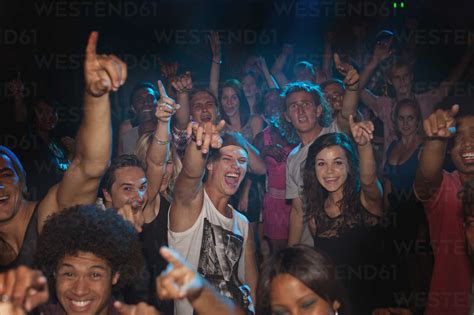 Enthusiastic crowd cheering at concert stock photo