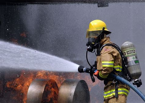 firefighter holding hose, firefighter, training, simulated plane fire ...