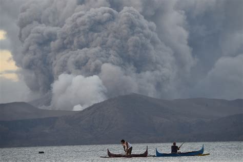 In Pictures: Taal volcano spews lava, sends ash clouds into sky ...