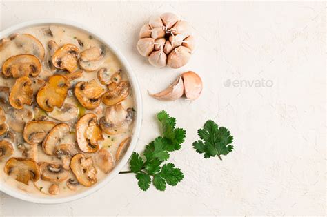 champignons in creamy garlic sauce, Stock Photo by Gala_Didebashvili