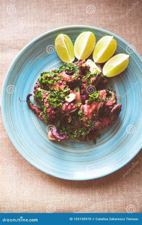 Octopus Tentacles Pan Fried With Herb Sauce Stock Photo - Image of ...