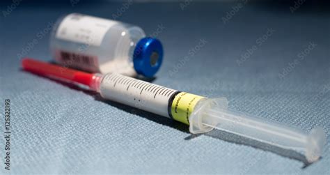 Syringe Filled in Propofol and Empty Vial on Blue Operating Room Cloth ...