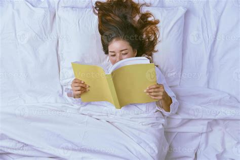 Young Woman Sleeping In Bed. Top view of young woman lying down ...