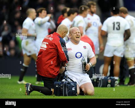 England's Dan Cole reacts in pain to treatment on an injury during ...